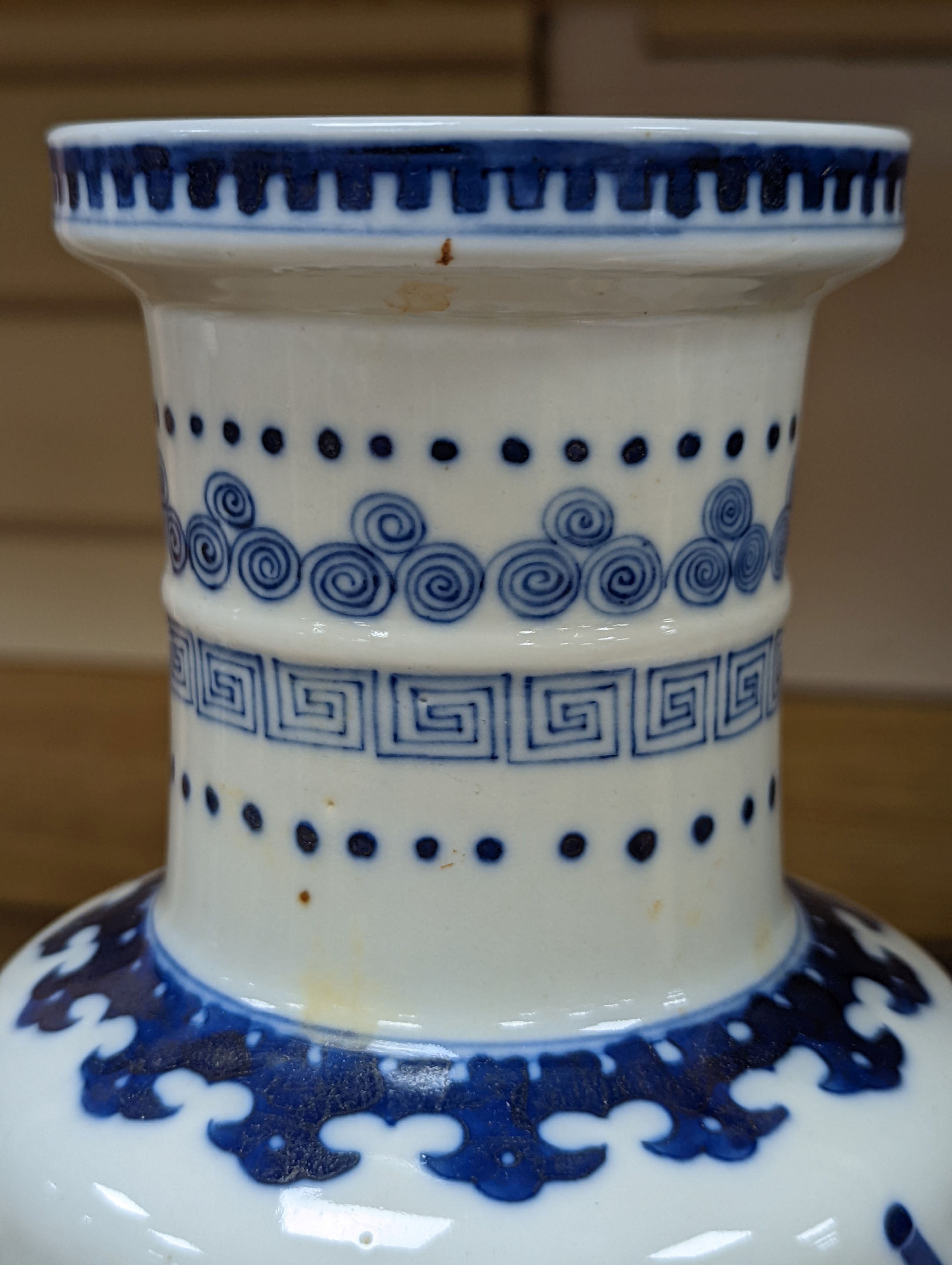 A Chinese blue and white rouleau vase, 35 cms.